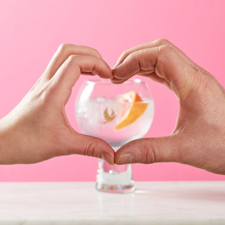 An Amplify and tonic framed by two hands in a heart shape.